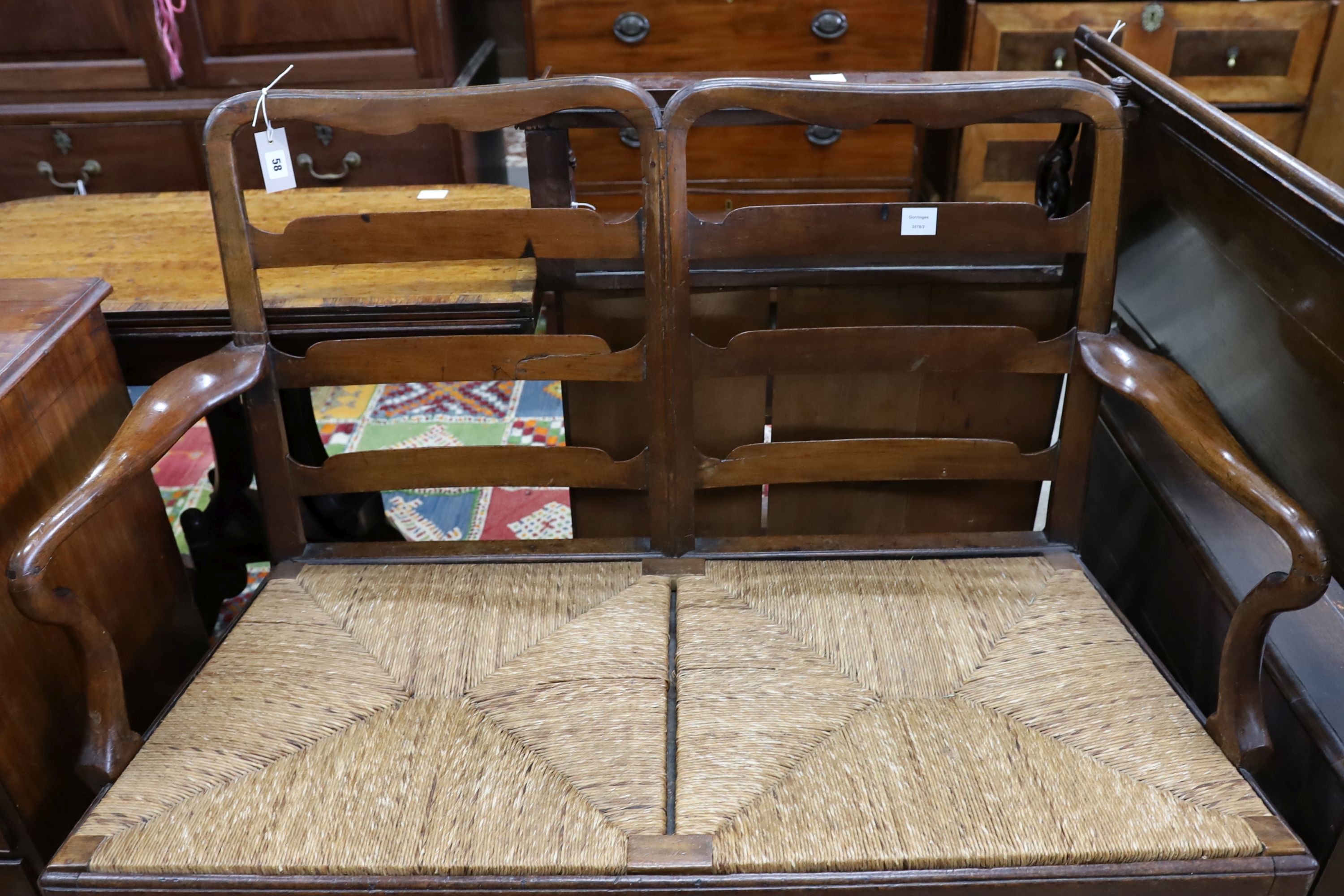 A George III provincial mahogany rush seat chair back settee, length 118cm, depth 53cm, height 100cm